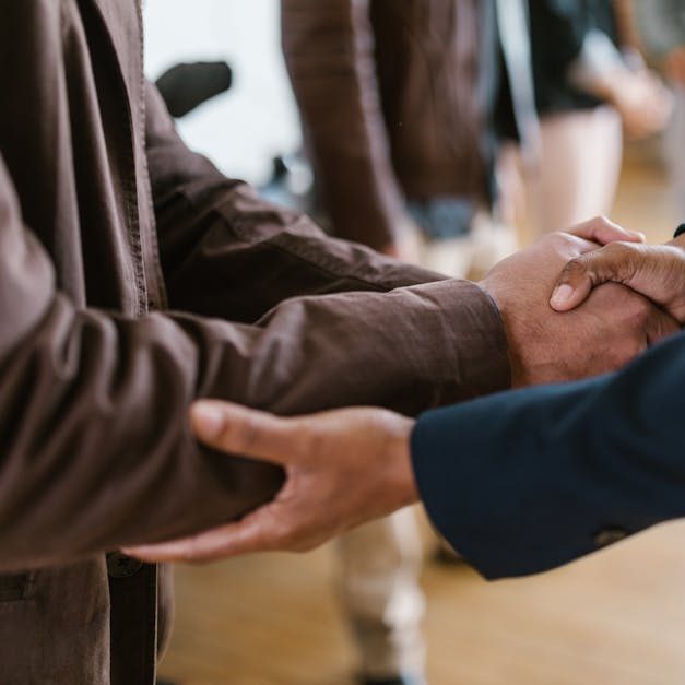 Close-up of two businesspeople shaking hands, symbolizing agreement and partnership.